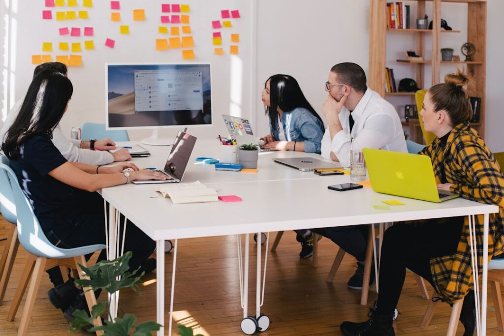 A team in an office discussing network monitoring software during a meeting